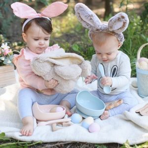 Two kids with bunny ears playing with silicone bowl set